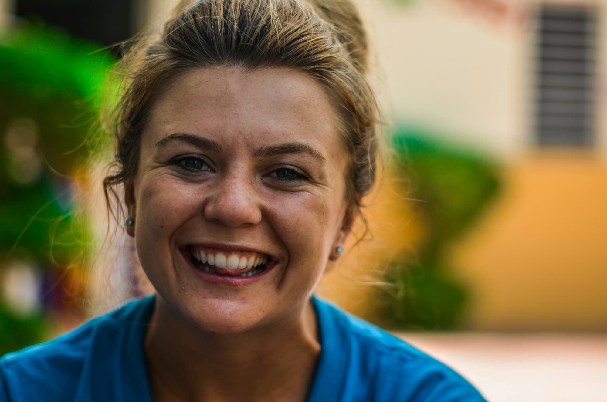 Portrait of a smiling woman against a plain background